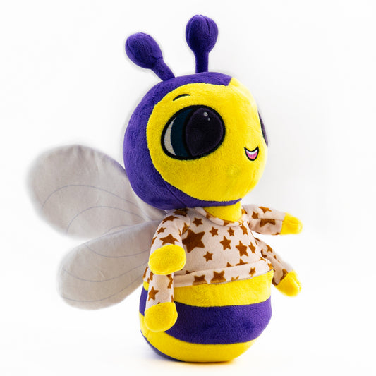 A musical plush toy, Billie Bumblebee hums the lullaby, You Are My Sunshine. Billie Bumblebee is pictured as a side view, it stands 12 inches tall from the bottom to the top of its antenna. Billie Bumblebee plushie is ultra soft and is shown in bright yellow and purple with white wings wearing a cream colored pajama top adorned with stars. Billie Bumblebees face also lights up with a soft soothing glow.