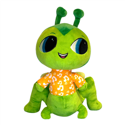 Green plush toy with large eyes and a yellow shirt on a white background