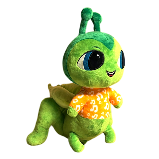 A musical plush toy, Colbie Cricket hums the lullaby, Hush Little Baby. Colbie Cricket is pictured as a side view, it stands 12 inches tall from the bottom to the top of its antenna. Colbie Cricket plushie is ultra soft and is a combination of emerald green, light green and a mint green wearing a light orange pajama top with music symbols. Colbie Crickets face also lights up with a soft soothing glow.