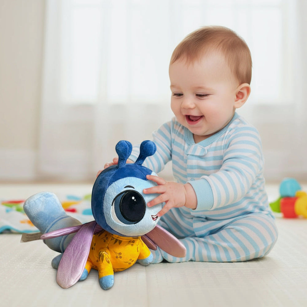 Baby playing with a colorful plush toy on a light-colored floor.