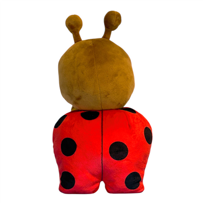 Back view of a plush Lexie ladybug toy with red body and black spots on a white background
